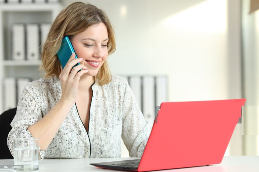 Friendly local insurance agent answering the phone in a Connecticut office