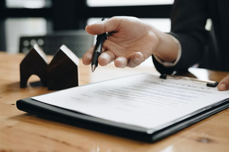 Insurance professional reviewing policy documents with a pen during a Connecticut insurance coverage review